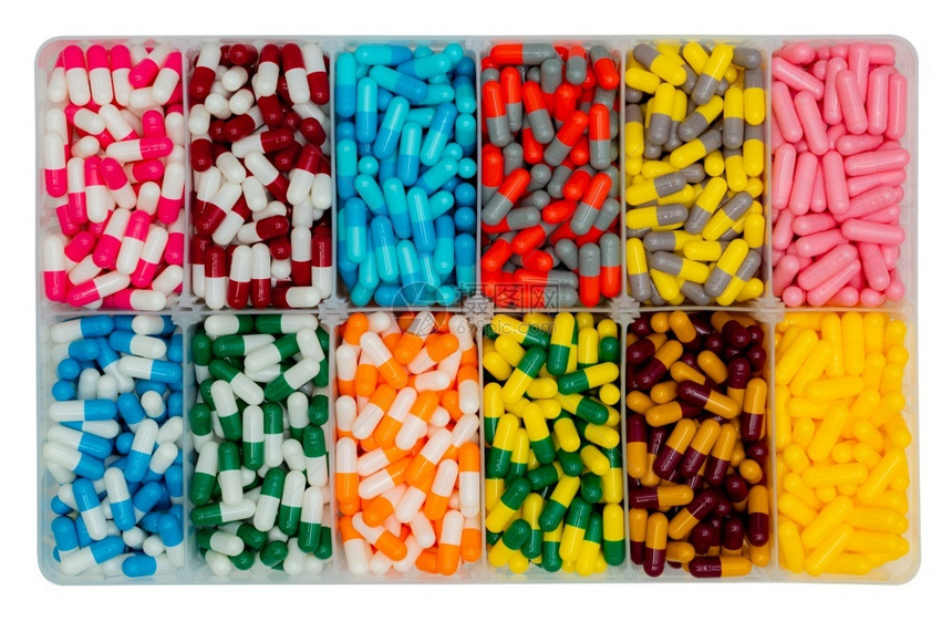 药剂学塑料盒中彩色胶囊药丸的顶端景象抗生素药物止痛维生素和补充胶囊药丸制业感染丸生产量片剂橙图片