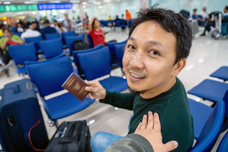飞机场沟通随意的候机时手抚亚洲肩在机场迎接朋友手拿大行李护照旅客和友好的概念快乐的高清图片素材