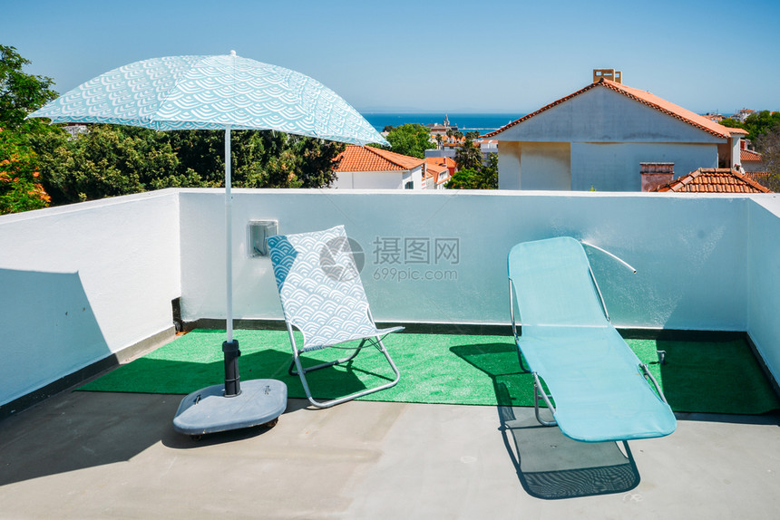 著名的罗滕贝格椅子葡萄牙卡斯伊享有大西洋海景的豪华避暑胜地露台上的日光浴床和遮阳伞葡萄牙卡斯伊享有大西洋海景的豪华避暑胜地露台上图片