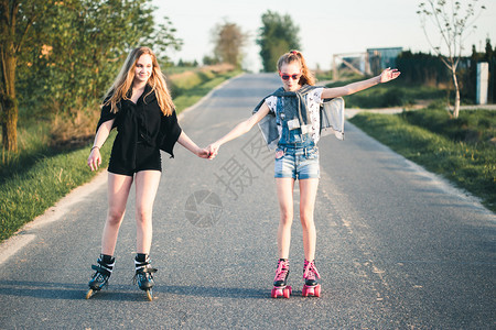 放松笑的年轻女孩在夏日共度愉快的滚溜乐趣真正的图片
