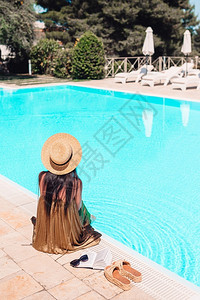 泳池边度假休闲的女人背影图片