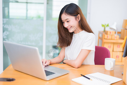 网上兼职素材亚洲女在办公室商业营销和兼职概念中使用笔记本电脑和互联网时享受生活在网上购物和商业成功主题上愉快地做工作乐的心情邮政专业卖背景