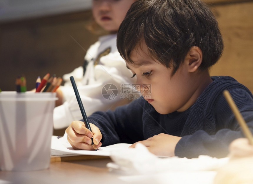 学龄前儿童可选择的在等待食物补充时儿童有选择的焦点享受纸上绿色铅笔颜的写作对有家庭的儿童来说是活具有家庭的儿童来说是活与父母一起图片