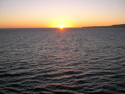 海上日落海洋海浪波纹太阳背景图片