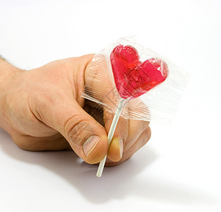 人手握着心形糖果背景图片