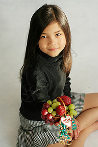 带着小果篮的小女孩孩子混血浆果展示小吃甜点篮子礼物水果黑发背景图片
