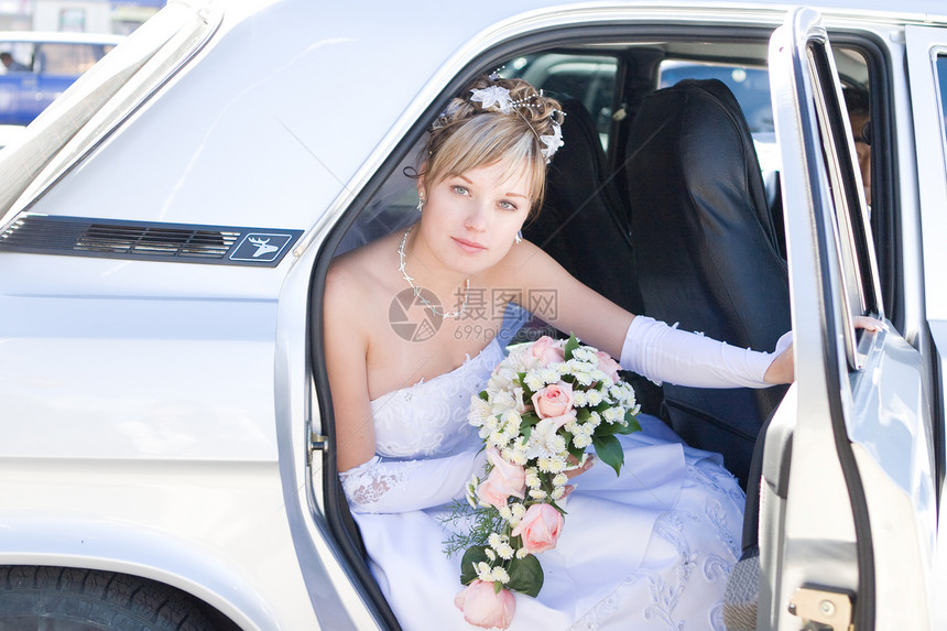 新娘在汽车中的新娘喜悦已婚快乐旅行庆典成人花束幸福太阳车辆图片