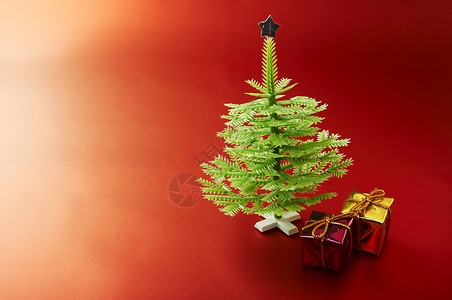 小型圣诞树星星礼物盒子红色塑料枞树宏观背景图片