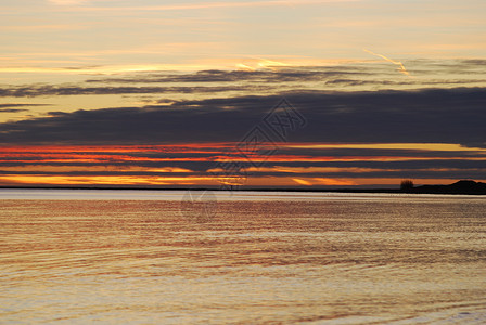 Falsterbo海滩日落橙子黑色海浪天空太阳蓝色高清图片