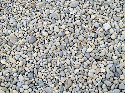 平滑的河石宏观岩石海岸线椭圆形石头材料巨石卵石砂岩矿物质背景图片
