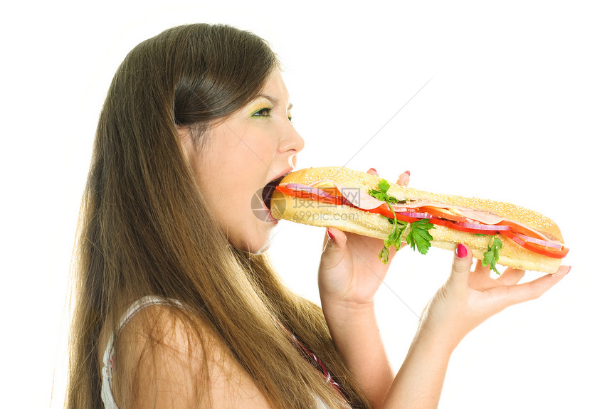 吃一个大汉堡包的漂亮女孩图片