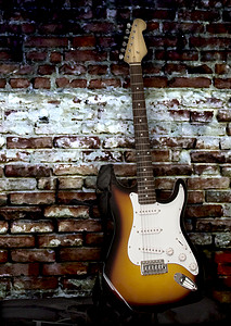吉他靠墙背景图片