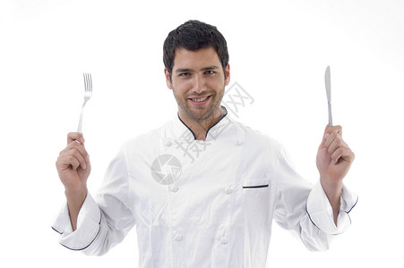 拿着刀叉的英俊厨师背景图片