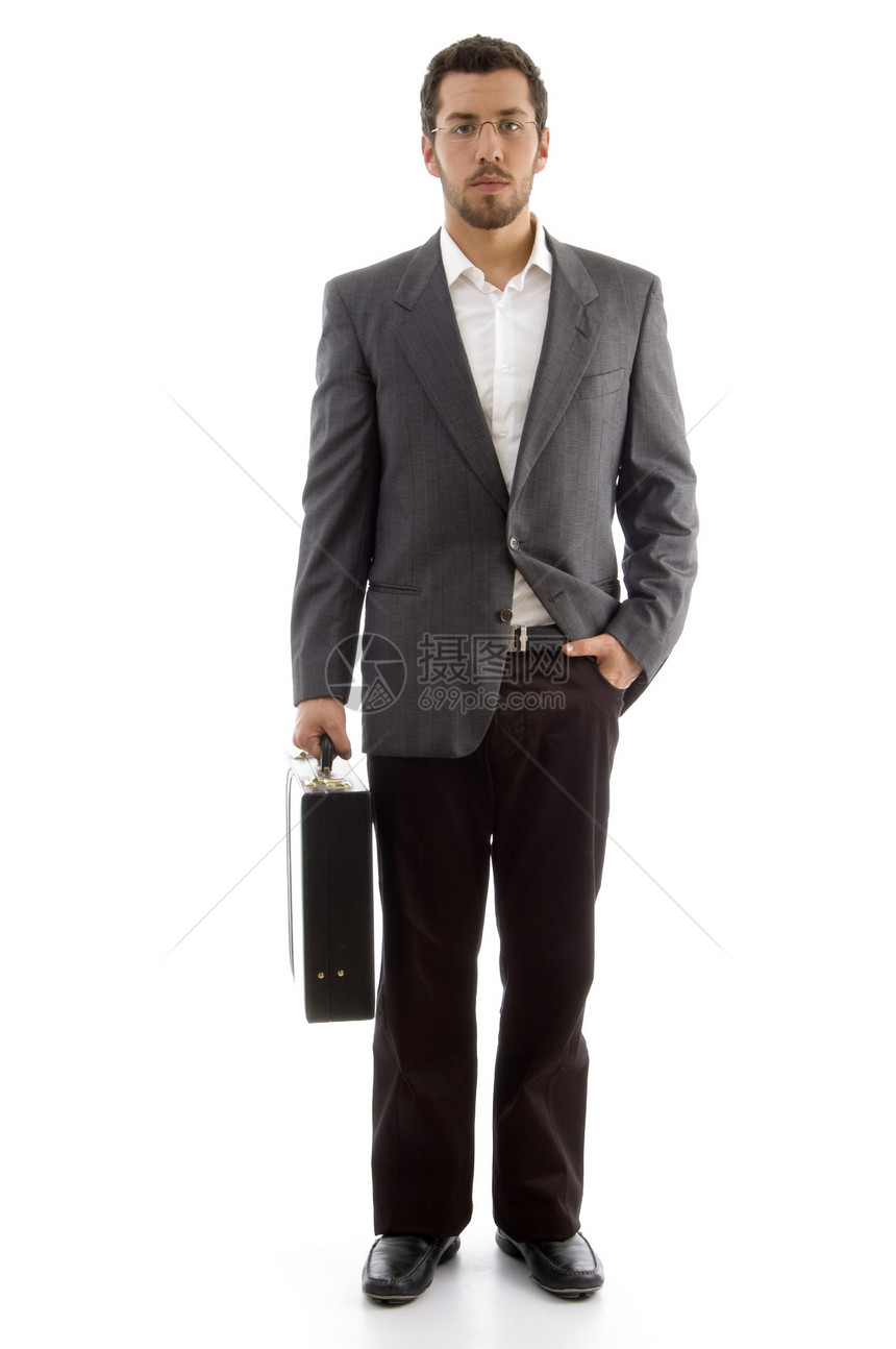 英俊的商务人士站在他的办公室包里图片