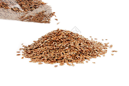 Linseed 被从一个袋子中灌满粮食种子亚麻小吃棕色谷物饮食食物营养白色背景图片