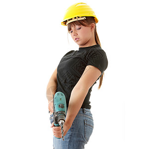 配备钻井机的年轻女性建筑工钻孔钻头木匠工具腰带维修建筑头盔女孩工作微笑高清图片素材