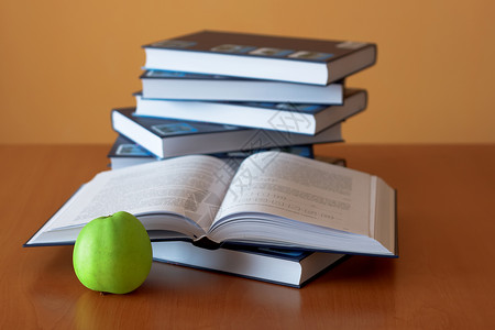 绿苹果 在办公桌上开书背景图片