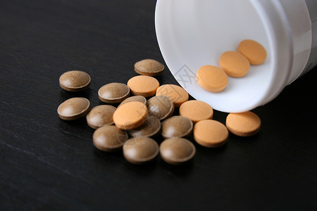 药片问题白色橙子止痛药瓶子医疗健康药物棕色背景图片