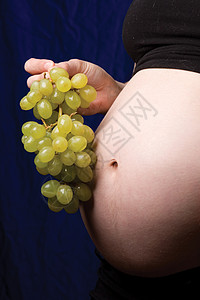 怀孕肚子母性腹部婴儿关系水果食物孩子联盟营养葡萄干背景图片
