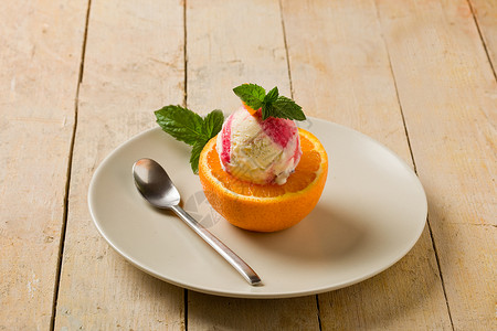 橙色冰淇淋桌子乳制品奶油状牛奶叶子水果创意茶匙橙子甜点背景图片