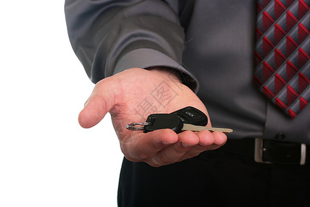 手持密钥衬衫行动钥匙电子产品指甲男人商业手指袖子灰色背景图片