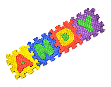 安迪库存玩具积木照片黄色蓝色绿色字母免版税紫色背景图片