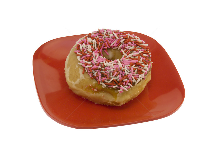 甜甜圈洒在红盘子上图片