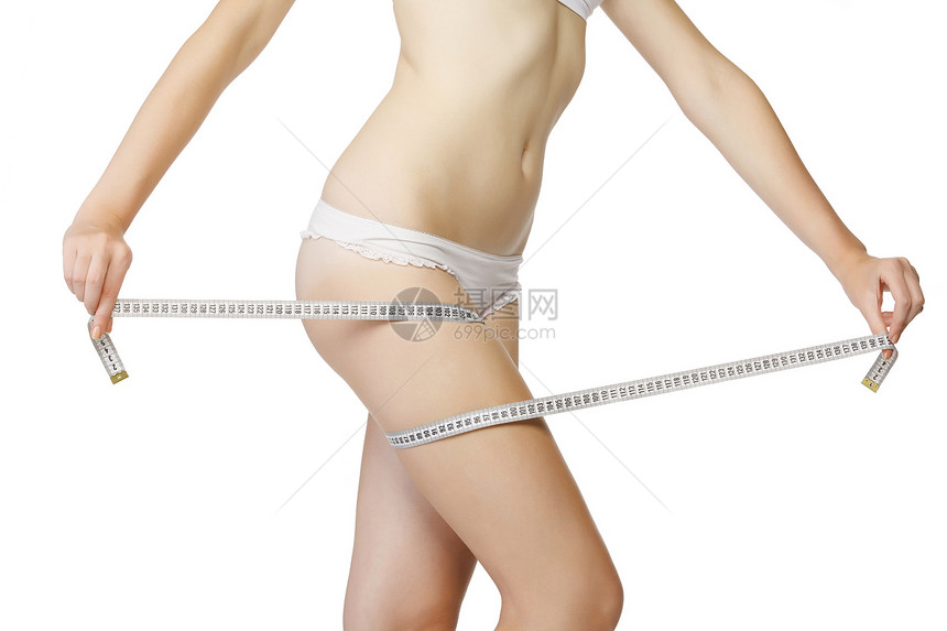 妇女用白色胶带测量她的大腿肥胖美丽女孩腰部数字磁带训练饮食腰围营养图片