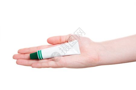 药用牙膏手头上有管状药膏 在白色上隔离背景