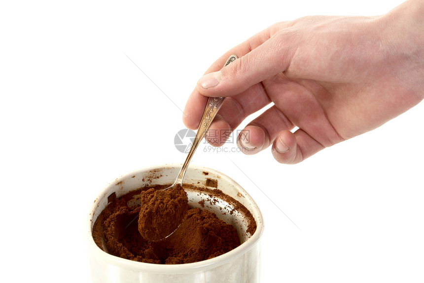 男人用勺子的手 从咖啡研磨机里拿咖啡来图片