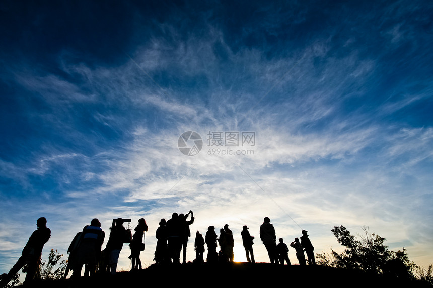 清晨人们在山上阳光照耀太阳女士男人顶峰地平线爬坡轮廓游客日落天空图片