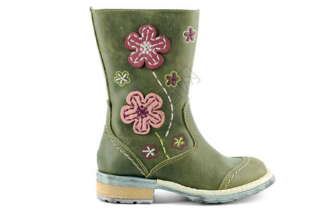 小女孩的皮革冬靴女孩孩子鞋类衣服绿色背景图片