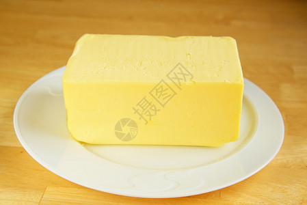 盘子上的黄油生产黄色桌子公克食物白色农业棕色产品牛奶背景图片