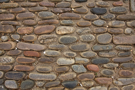 在欧洲一条街道上铺筑路障的格局城市对角线石头材料椭圆形说谎背景图片