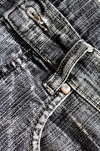Denim 背景牛仔布宏观拼接接缝裤子标签铆钉纺织品衣服材料背景图片