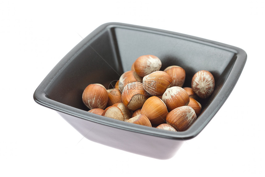 白边隔绝的碗里的栗子种子食物宏观力量水果木头摄影棕色榛子豆类图片
