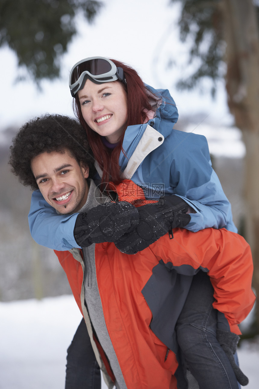 在雪地风景中骑着小男孩给女孩搭便车两个人笑声季节围巾感情女士下雪寒冷男人夫妻图片