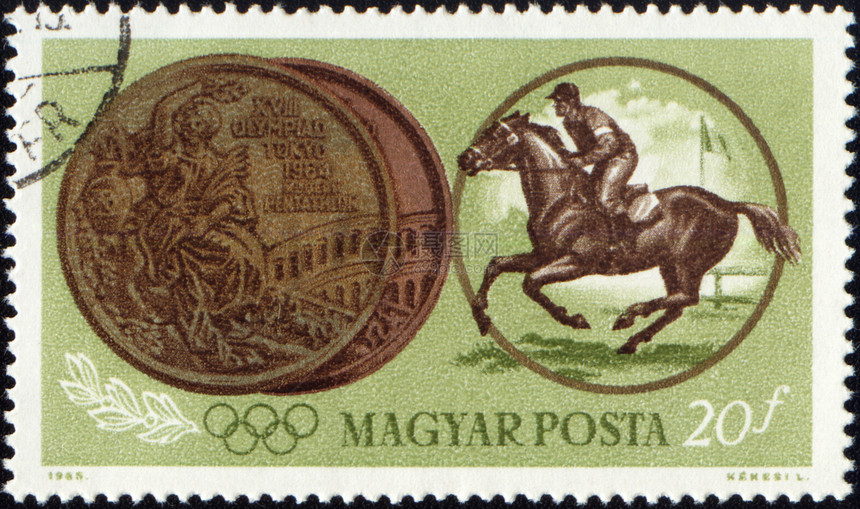 骑马运动员和印有邮票的奥林匹克奖章图片