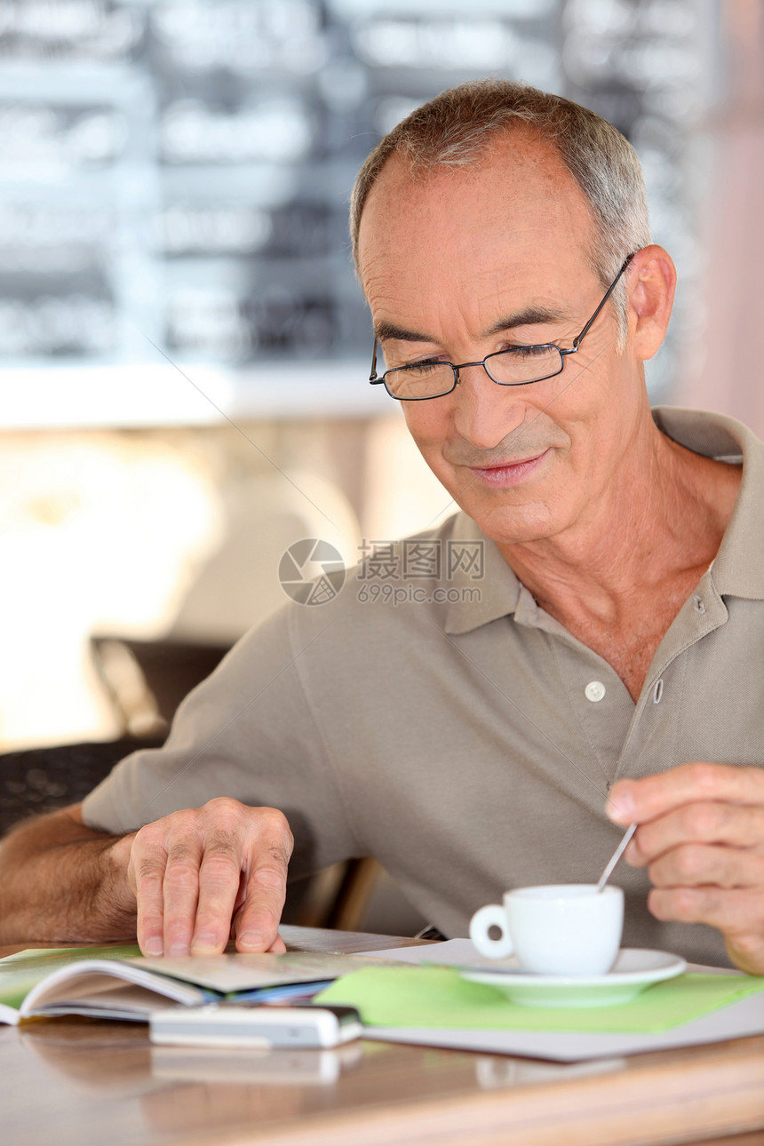 老人喝咖啡和看书图片
