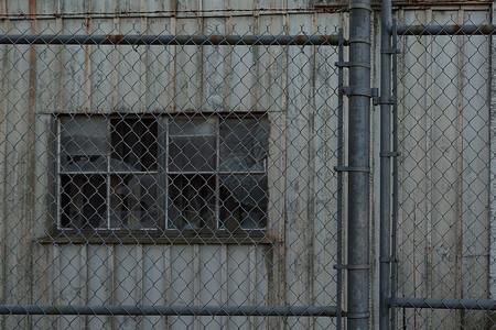 废弃仓库安全铁丝网栅栏窗户围栏灰色玻璃高清图片