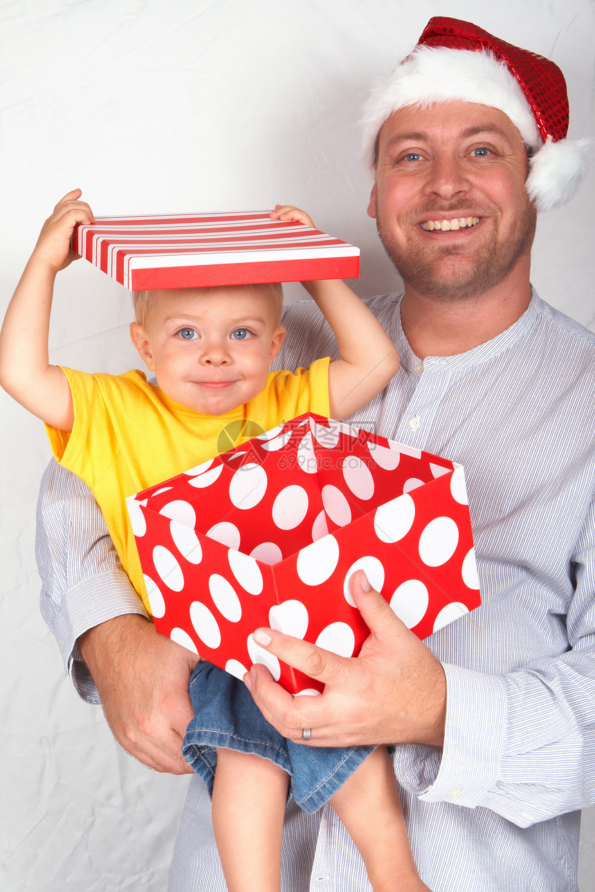 和父亲一起过圣诞的宝贝男孩帽子展示孩子微笑金发女郎男性蓝色家庭男人盒子图片