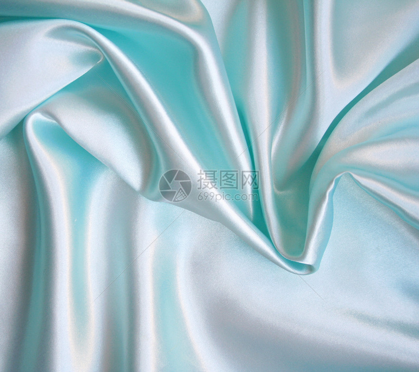 平滑优雅的蓝色丝绸作为背景折痕海浪织物曲线银色纺织品布料投标材料紫丁香图片