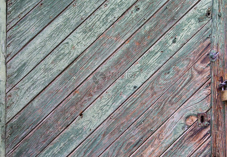 从木板门露出木瓜的绿油漆剥削金属木头装饰品建筑锁孔古董安全地面房子风化图片