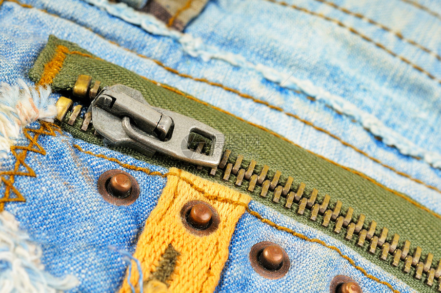 牛仔裤口袋的拉链压缩棉布衣服服装材料纹理接缝靛青蓝色纺织品图片