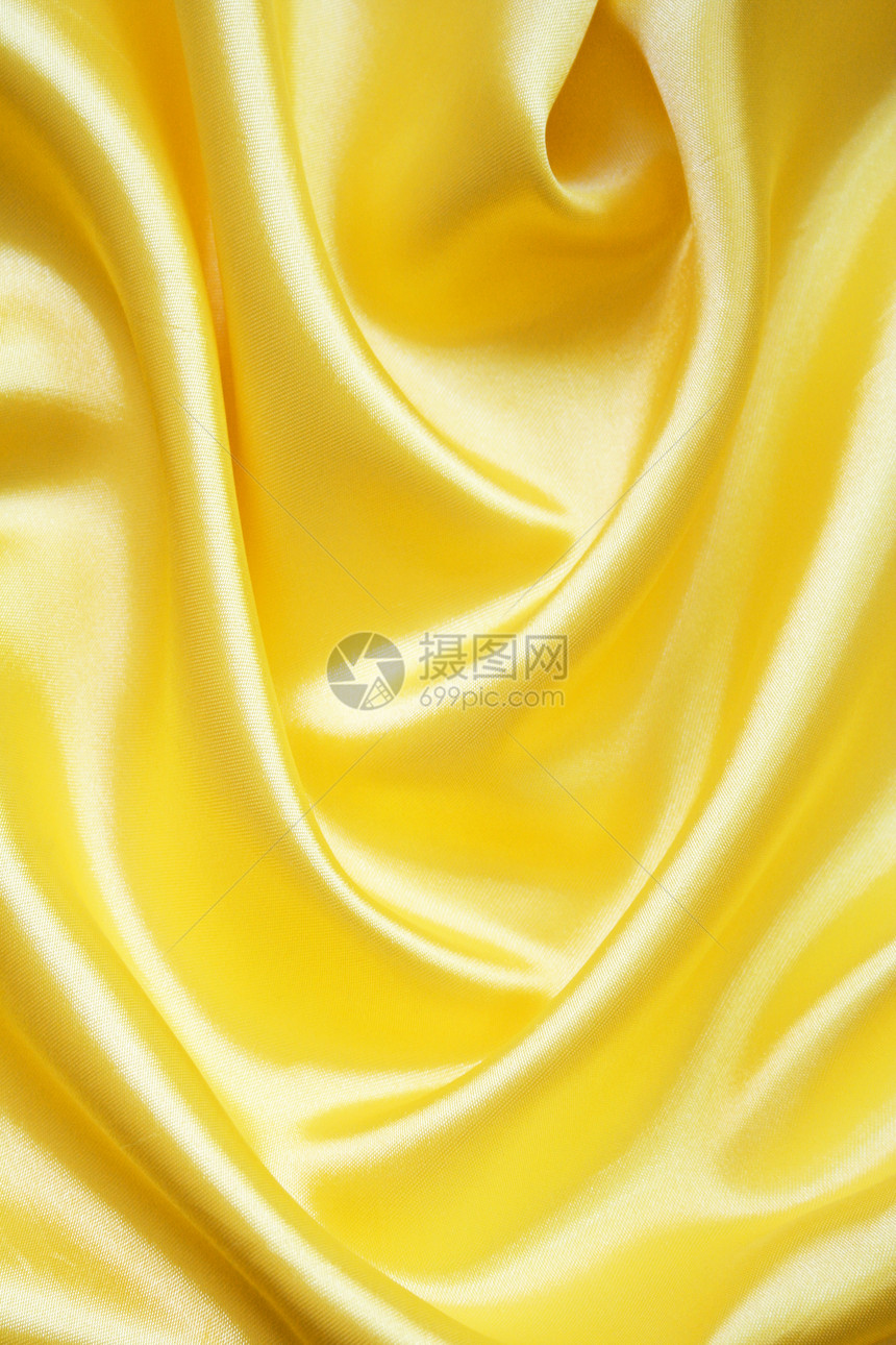 平滑优雅的金色丝绸可用作背景织物涟漪折痕纺织品黄色布料投标材料海浪曲线图片