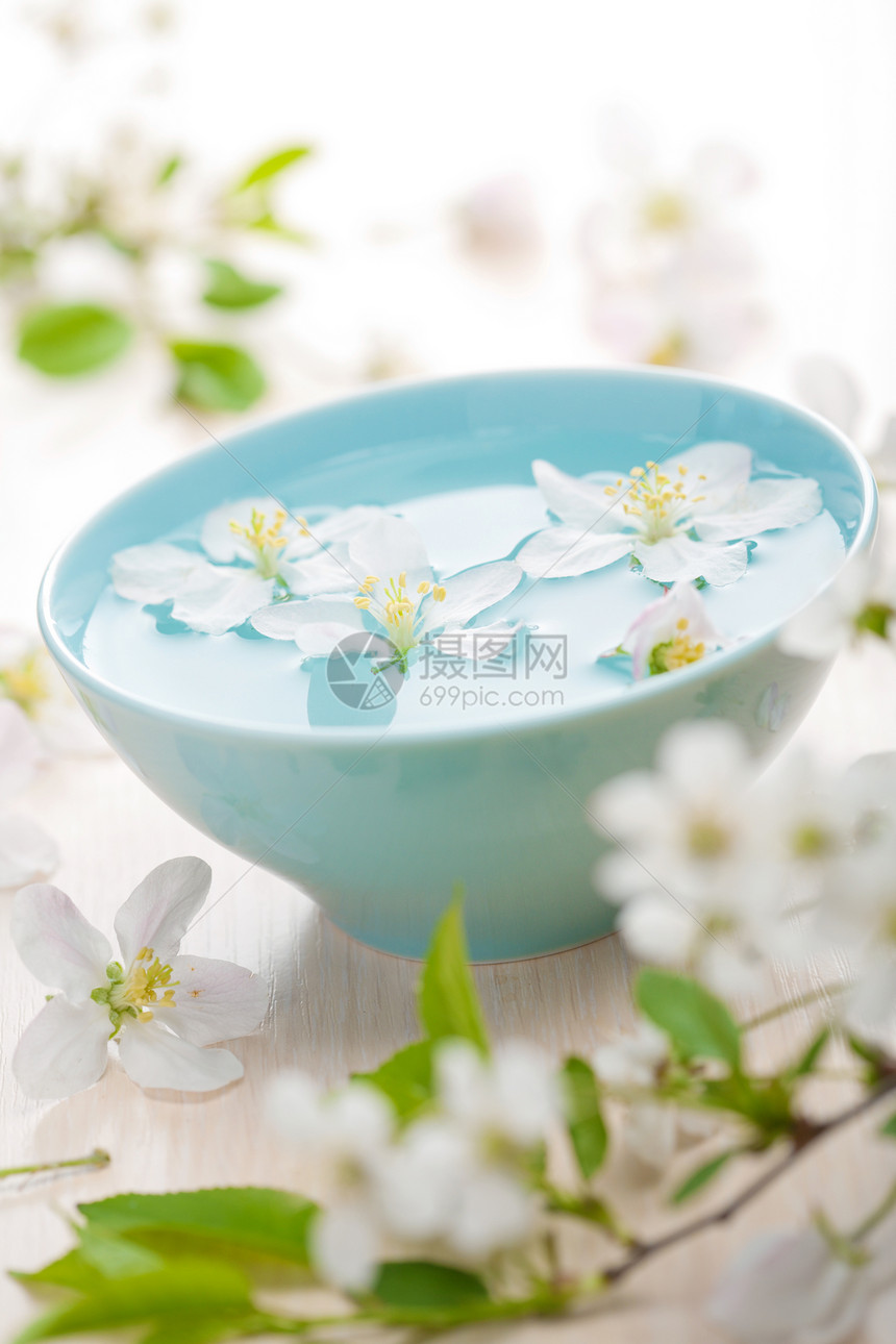 用于温泉和芳香治疗的春花疗法蓝色白色装饰风格植物香气木头盘子花瓣图片