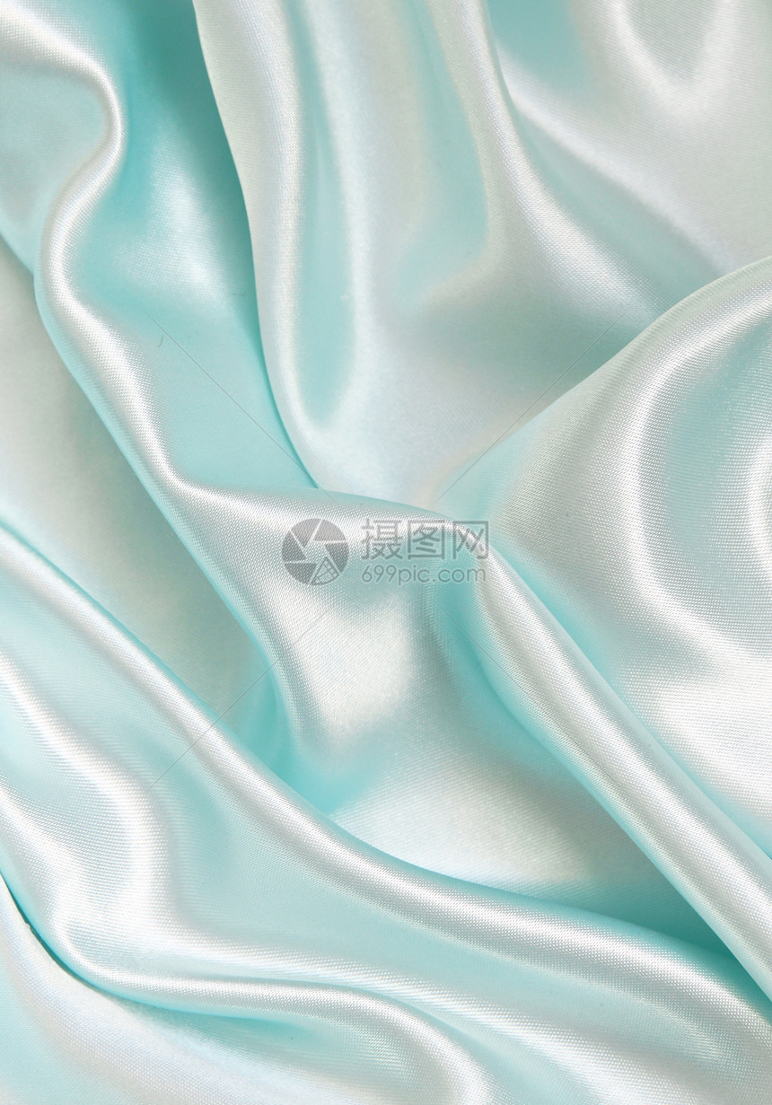 平滑优雅的蓝色丝绸作为背景织物布料投标海浪银色折痕曲线纺织品材料图片
