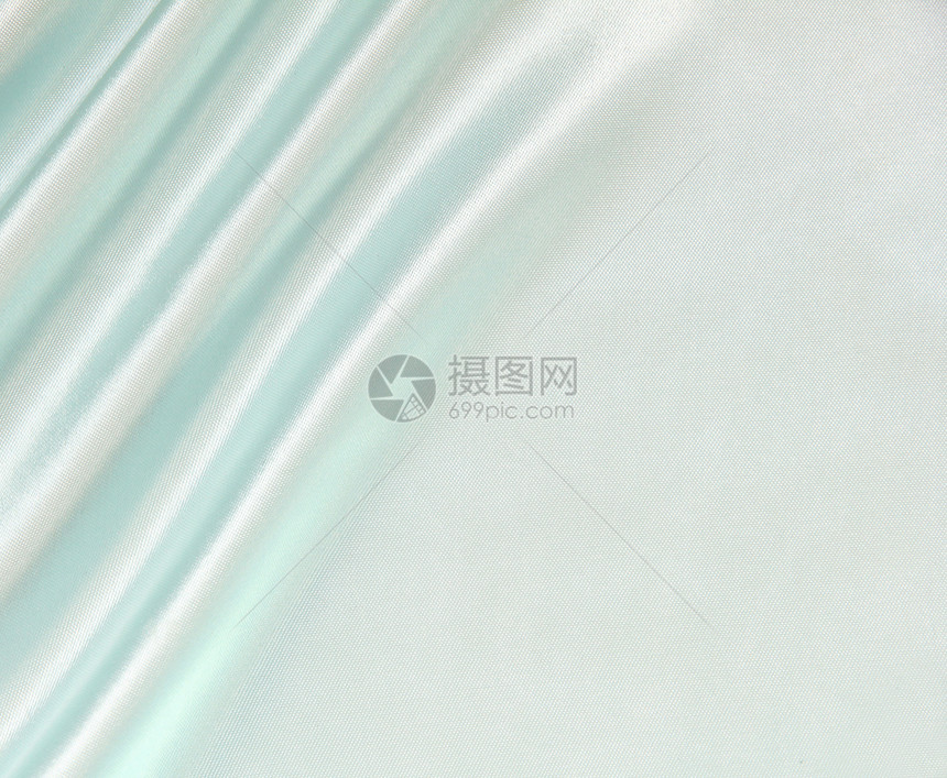 平滑优雅的蓝色丝绸作为背景纺织品折痕布料海浪曲线投标材料织物银色图片