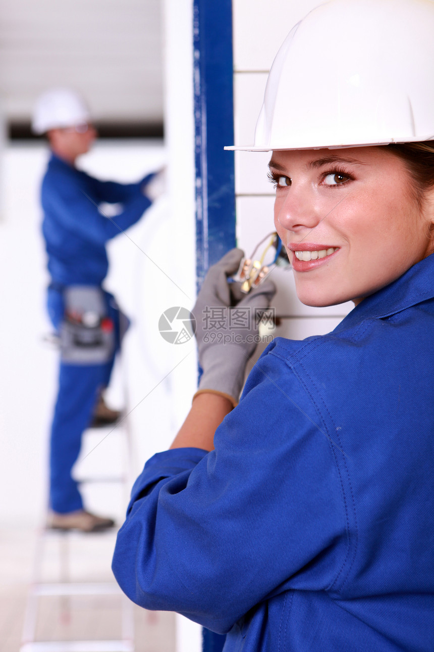 安装电源点的女电工建筑工人蓝色女士建设者改造插座职业工作女性图片