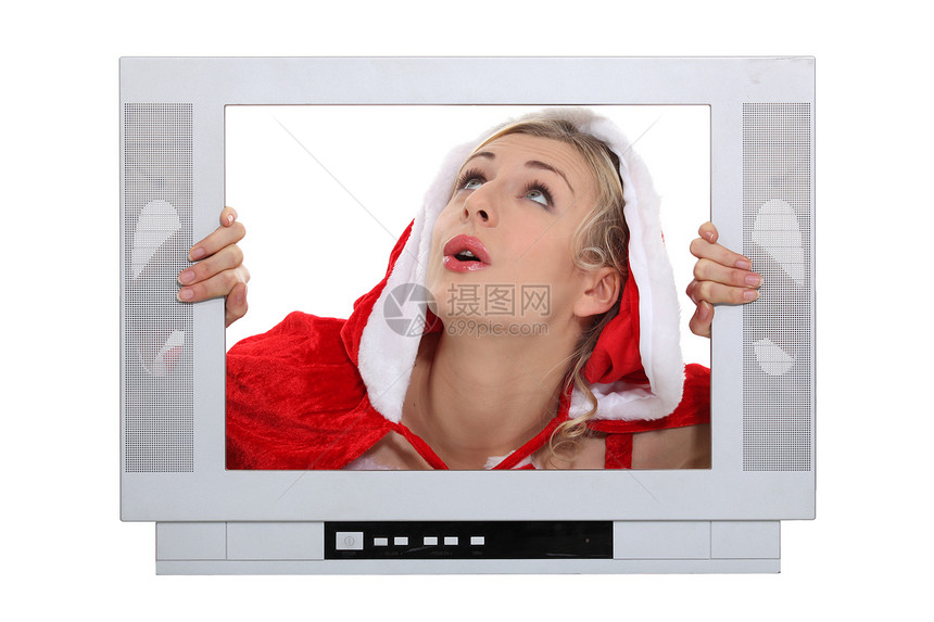 在电视后面有圣诞一层框架的妇女图片